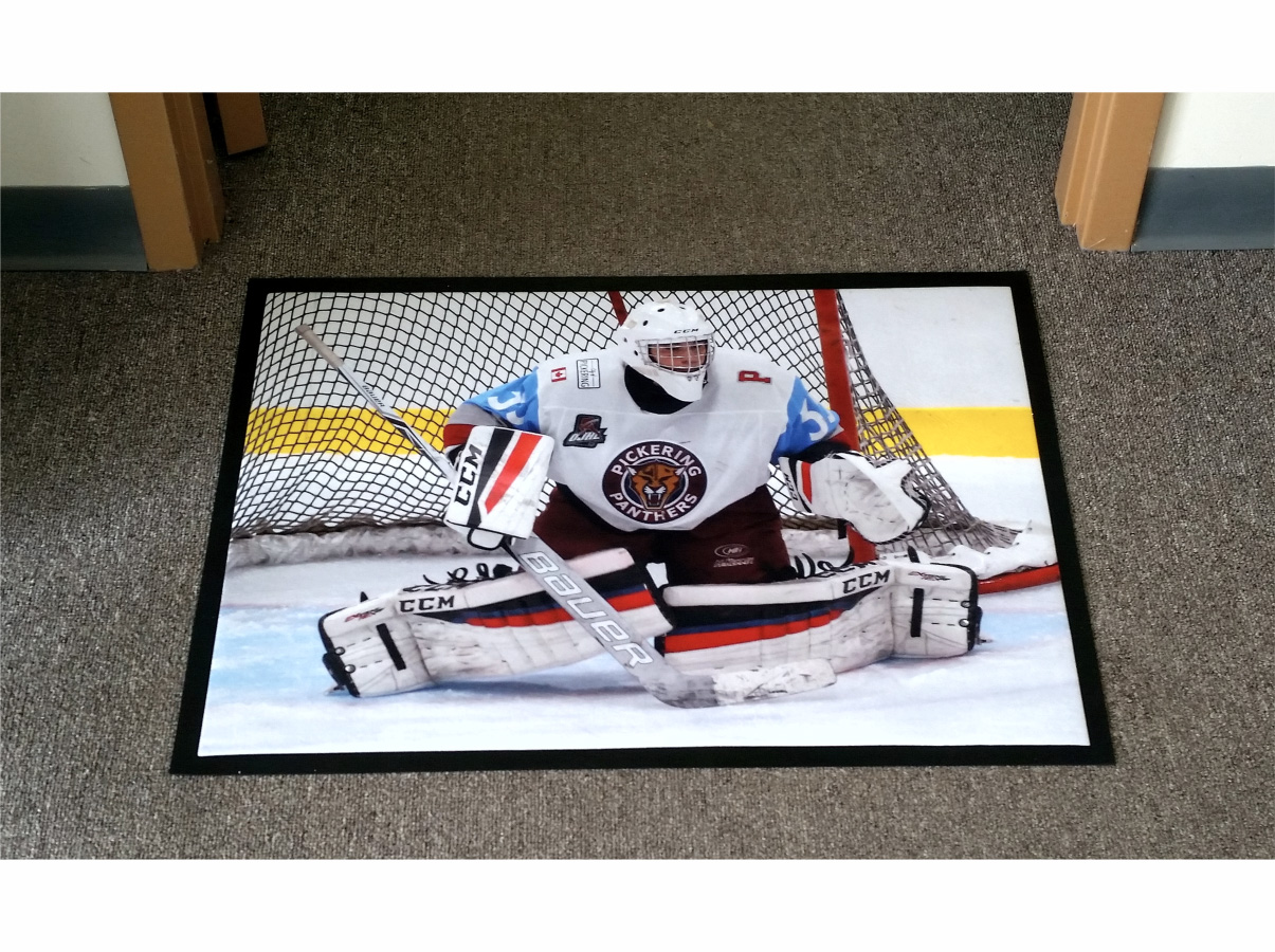 Floor mat with a hockey goalie in front of the net