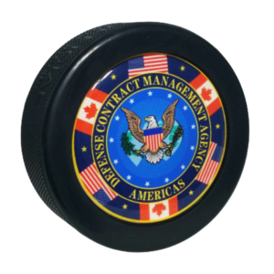 Defence Contract Management Agency Americas logo on a domed hockey puck