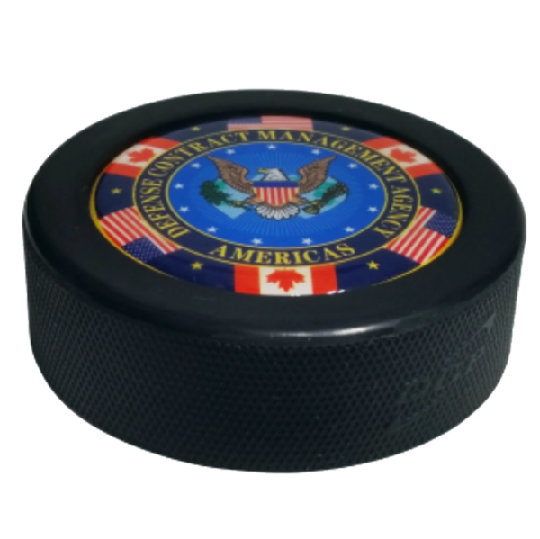 Domed hockey puck with the Defence Contract Management Agency Americas logo