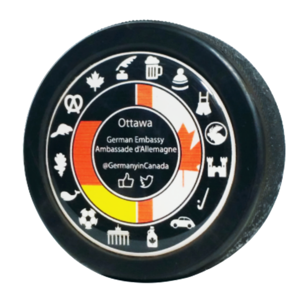 Ottawa German Embassy @GermanyinCanada logo with Canadian and German symbols on a domed puck