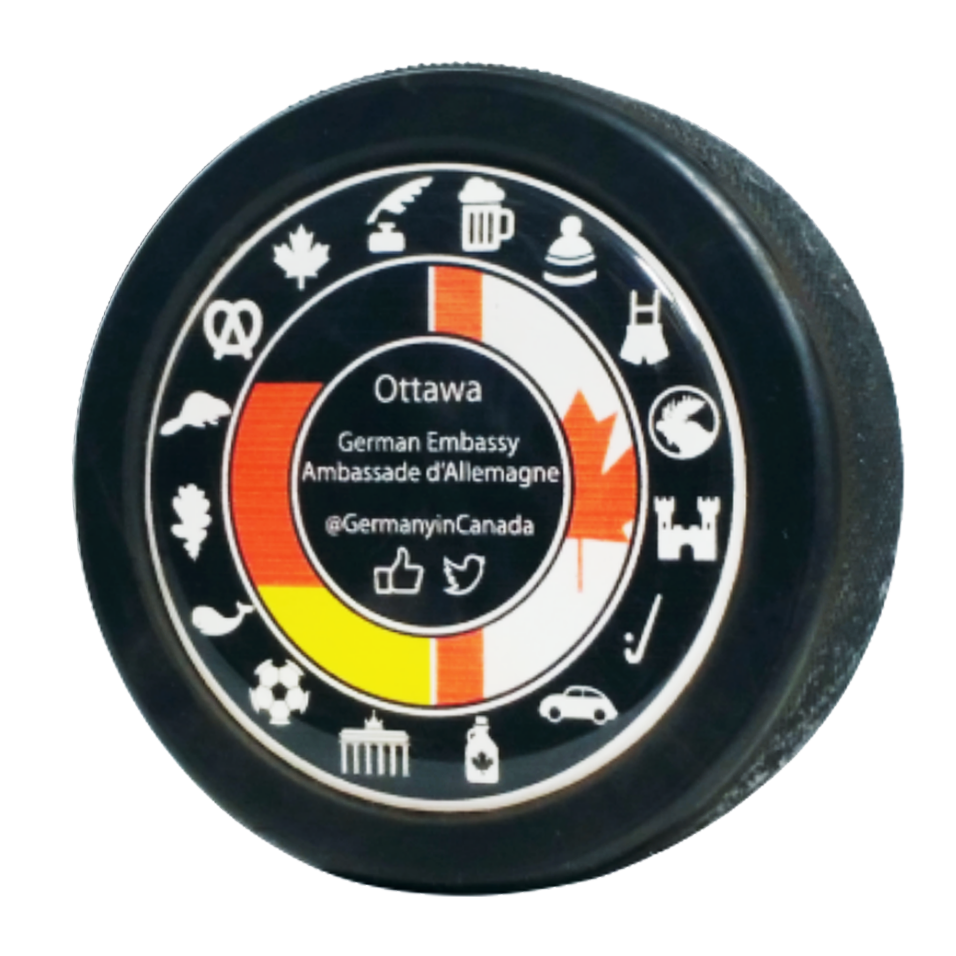 Ottawa German Embassy @GermanyinCanada logo with Canadian and German symbols on a domed puck