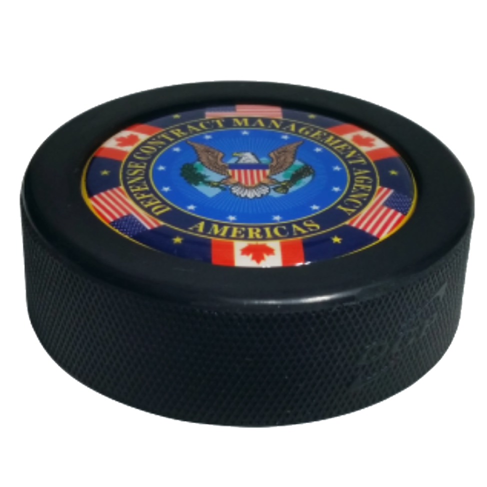 Domed hockey puck with the Defence Contract Management Agency Americas logo