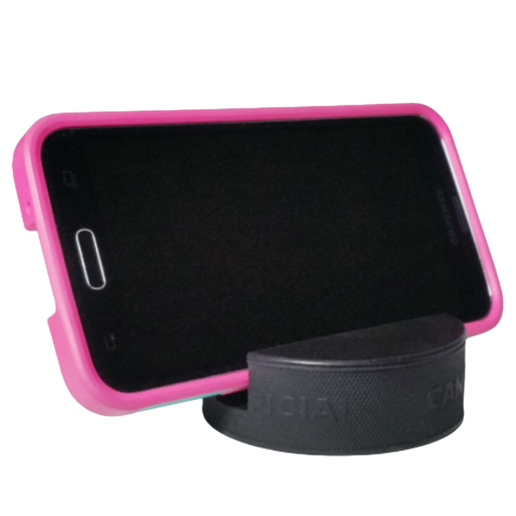 Smartphone in a pink protective case in a black puck holder
